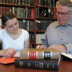 2 people reading a book