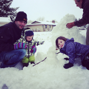 Paramedic playing in the snow with his kids