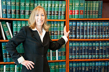 Standing in front of a bookcase of law books